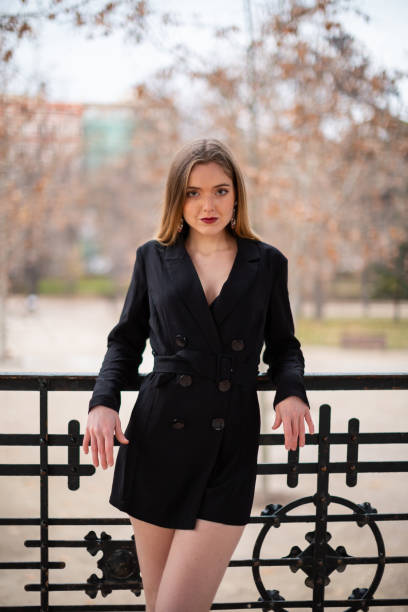 istock Pretty model woman posing in a park resting on a fence 1092128646