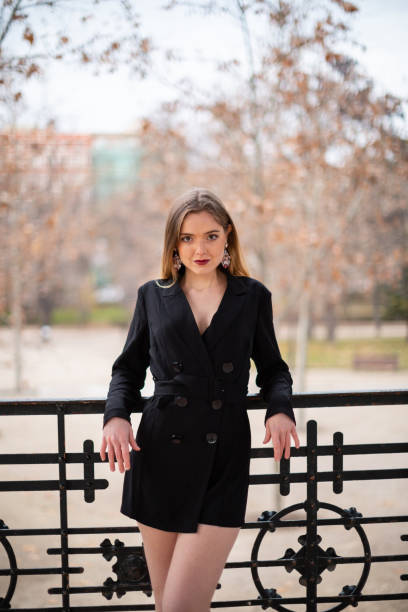 istock Pretty model woman posing in a park resting on a fence 1092128656