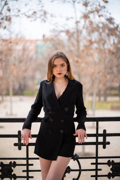 istock Pretty model woman posing in a park resting on a fence 1092128738