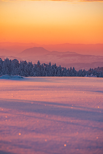Sunrise over the snowy mountain landscape.