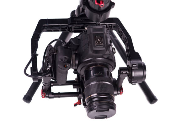 istock System stabilization video camera and lens on steady equipment support such as gimbal steady or stabilized. White background 1092130774