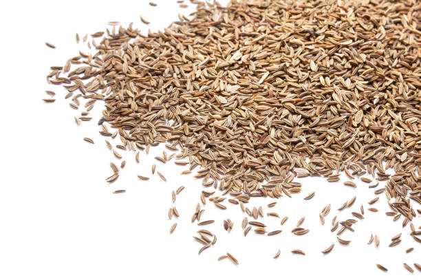 istock Pile of cumin seeds on white background 1092130812