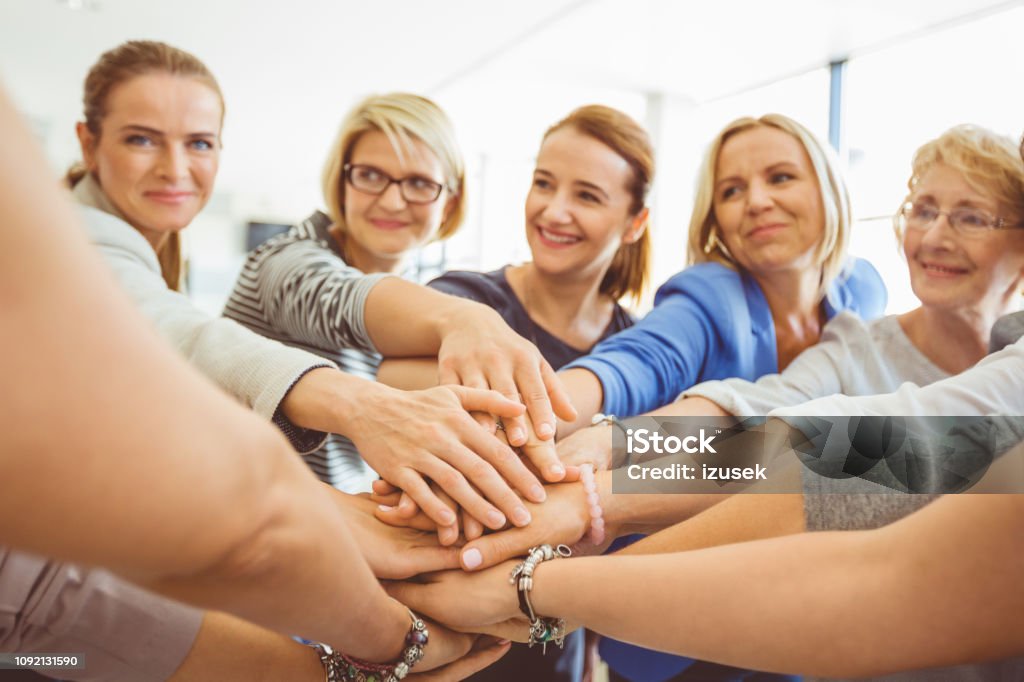 Stack of hands showing unity and teamwork Group of women hands stacked over each other in office. Female with stack of hands showing unity and teamwork. A Helping Hand Stock Photo Stack of hands showing unity and teamwork Group of women hands stacked over each other in office. Female with stack of hands showing unity and teamwork. A Helping Hand Stock Photo