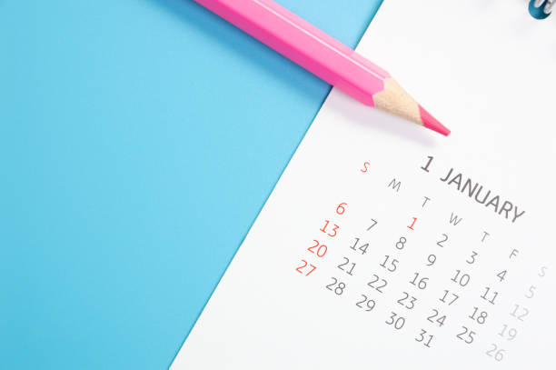 istock red pencil and calendar on blue background 1092132304