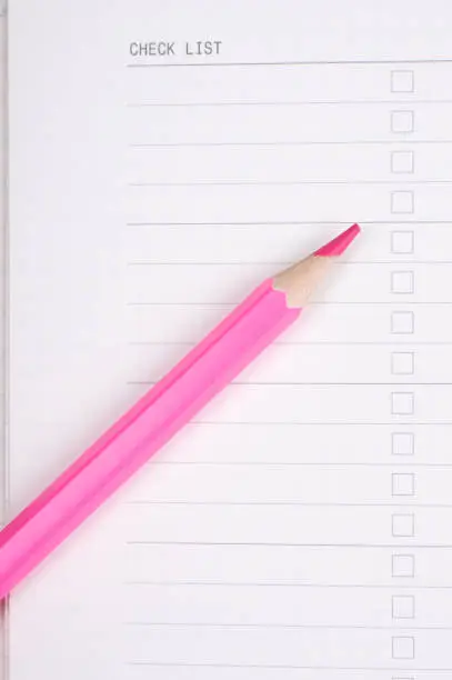 red or pink pencil on white note