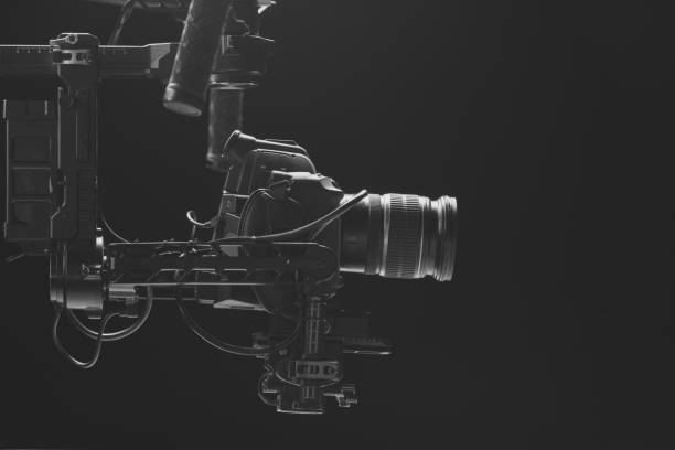 istock System stabilization video camera and lens on steady equipment support such as gimbal steady or stabilized. Black background 1092134552