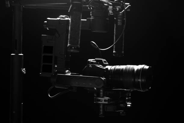 istock System stabilization video camera and lens on steady equipment support such as gimbal steady or stabilized. Black background 1092134568