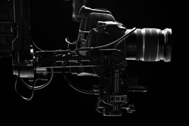 istock System stabilization video camera and lens on steady equipment support such as gimbal steady or stabilized. Black background 1092134578