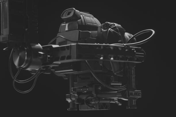 istock System stabilization video camera and lens on steady equipment support such as gimbal steady or stabilized. Black background 1092134622