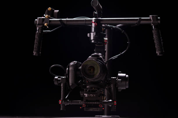 istock System stabilization video camera and lens on steady equipment support such as gimbal steady or stabilized. Black background 1092134694