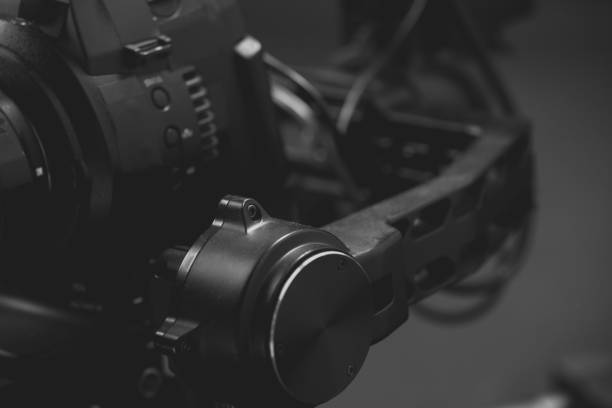 istock System stabilization video camera and lens on steady equipment support such as gimbal steady or stabilized. Black background 1092134732