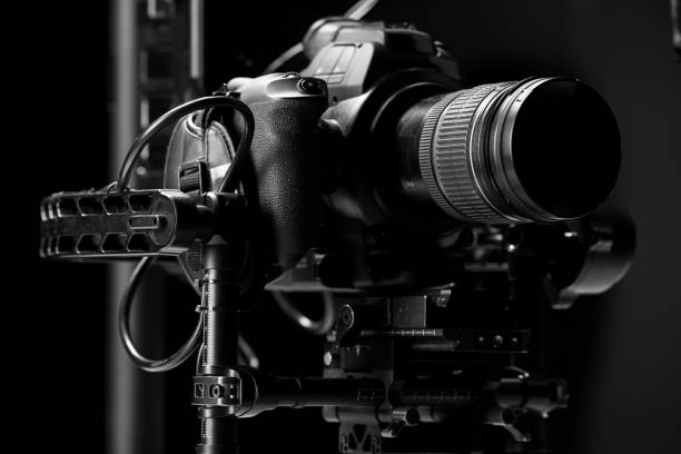 istock System stabilization video camera and lens on steady equipment support such as gimbal steady or stabilized. Black background 1092134802