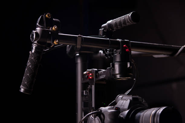 istock System stabilization video camera and lens on steady equipment support such as gimbal steady or stabilized. Black background 1092134816