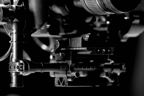 istock System stabilization video camera and lens on steady equipment support such as gimbal steady or stabilized. Black background 1092134860