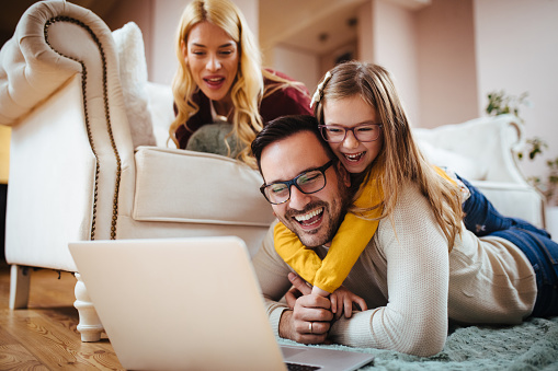 Family at home using laptop