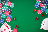Casino games related items on green table, copy space