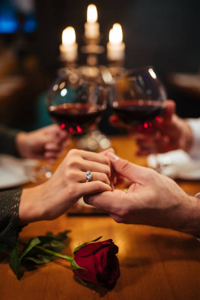 istock Couple holding hands during romantic dinner in a restaurant 1092137108