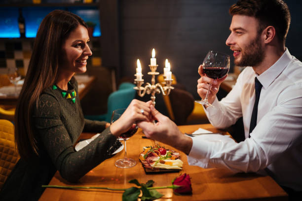 istock Couple holding hands during romantic dinner in a restaurant 1092139370
