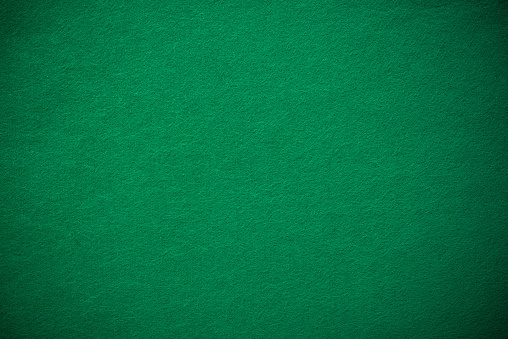 Empty green casino poker table cloth with spotlight