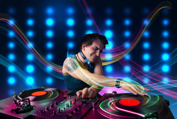 istock Young Dj mixing records with colorful lights 1092140770