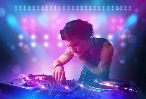 istock Disc jockey mixing music on turntables on stage with lights and stroboscopes 1092140932