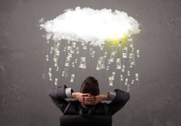 istock Business man in suit looking at cloud with falling money 1092142908