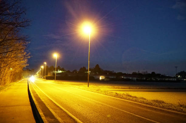 istock Road lights in night, street post shadow 1092144196