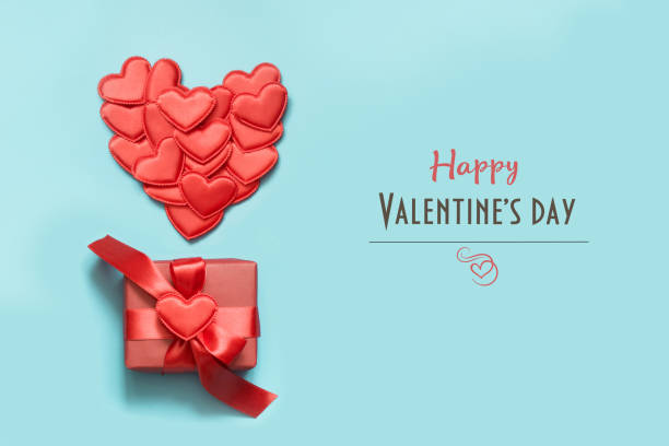 istock Valentine's day card. Invitation with gift, red hearts on blue. Top view. 1092145356