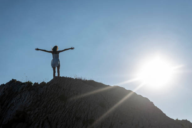 istock girl cheering on the rock 1092147468