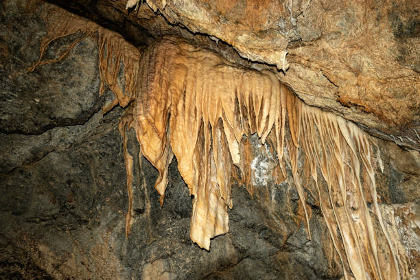 Interior of a mountain cave with stalactites and stalagmites in Tuscany, Italy, Europe