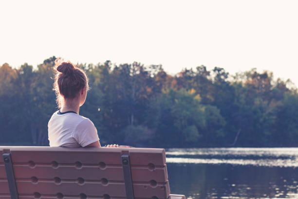 istock Girl seated on the bench admiring Nature 1092150918