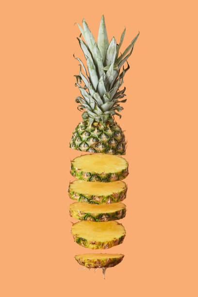 istock sliced tasty organic pineapple isolated on orange 1092152124