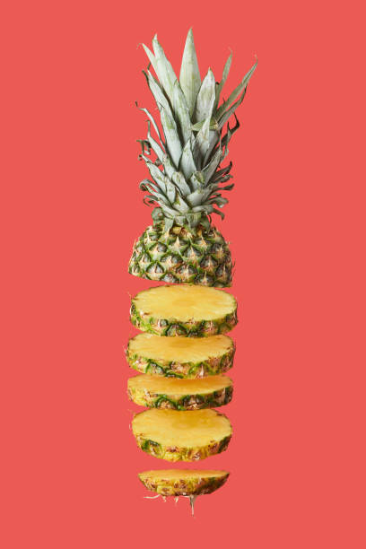 istock sliced, tasty and organic pineapple isolated on red 1092152134