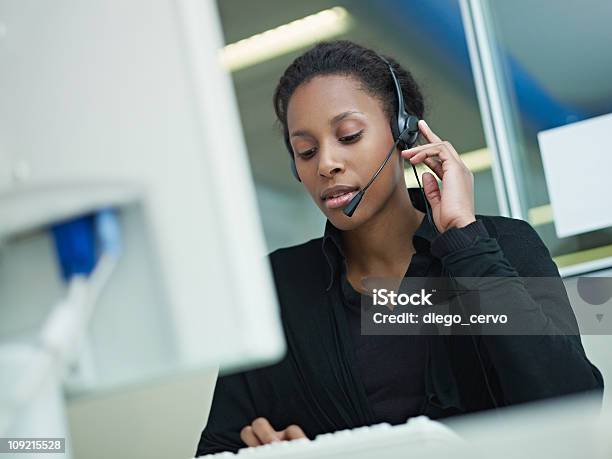 Woman Working In Call Center Stock Photo - Download Image Now - Serious, Customer Service Representative, Headset