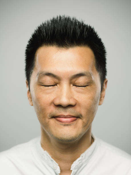 istock Real chinese man with happy expression and closed eyes 1092156416