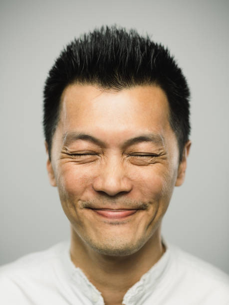 istock Real chinese man with excited expression and closed eyes 1092156488