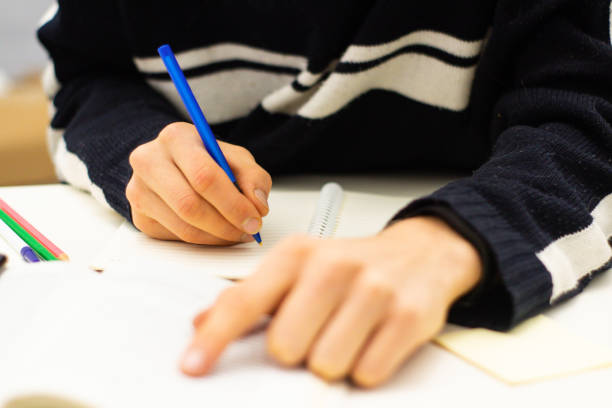 istock Hand writing on white paper. Education and business concept 1092157514