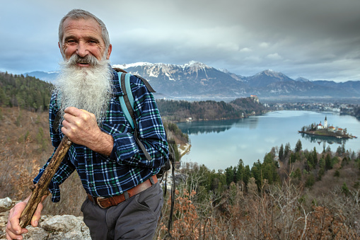 Happy Senior hiker with long beard over Bled, Gorenjska, Slovenia, Europe, Nikon D850