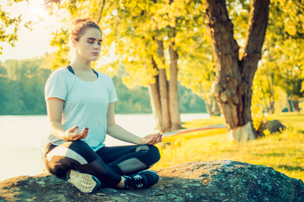istock Practicing Yoga at a Peaceful Location Near the Lake 1092163000