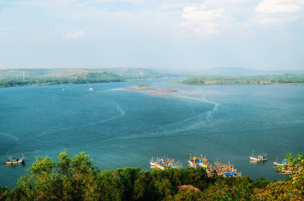 Chapora River, coastline view with boats, Goa, India Chapora river with fish market and fishing boats. View of Chapora and Morjim coastline from Chapora Fort, North Goa, India chapora fort stock pictures, royalty-free photos & images