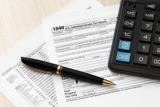istock US 1040 Tax Form, pen and calculator 1092165882
