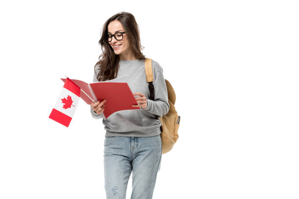 istock smiling female student with backpack holding canadian flag and notebook isolated on white 1092168286