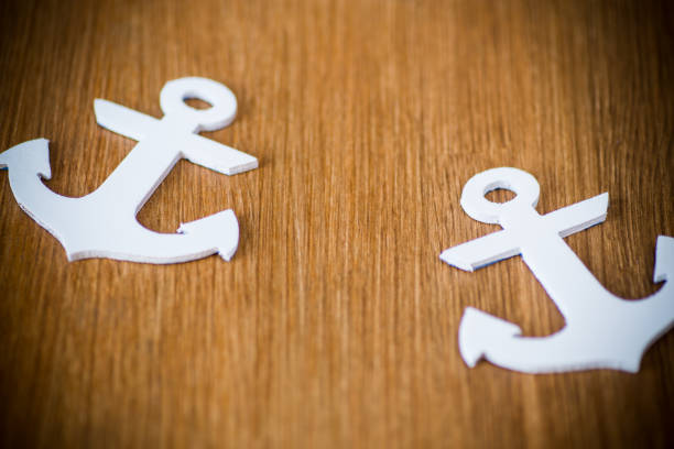 istock white decorative anchor on a wooden background 1092168402