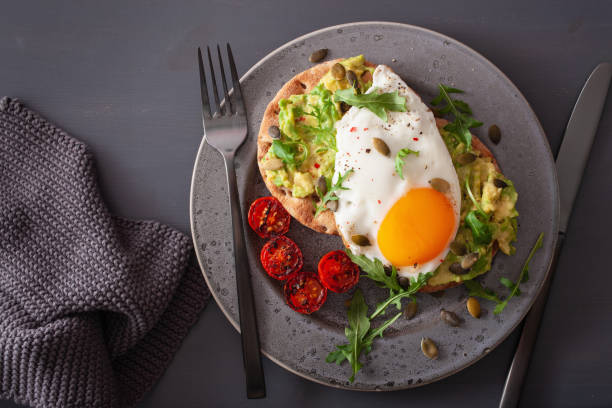 istock breakfast avocado sandwich with fried egg and tomato 1092168410