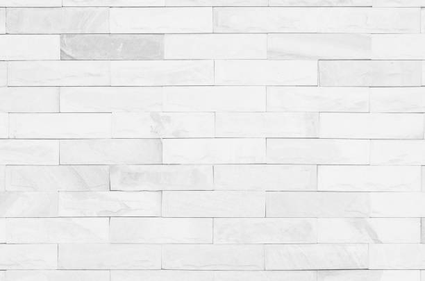 istock White brick wall art concrete or stone texture background in wallpaper limestone abstract paint to flooring and homework/Brickwork or stonework clean grid uneven interior rock old. 1092168678