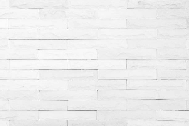 istock Seamless white pattern of decorative brick sandstone wall surface with concrete of modern style design decorative uneven have cracked realmasonry wall of multicolored stones or blocks white cement. 1092168682