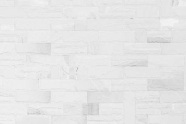 istock White brick wall art concrete or stone texture background in wallpaper limestone abstract paint to flooring and homework/Brickwork or stonework clean grid uneven interior rock old. 1092168684