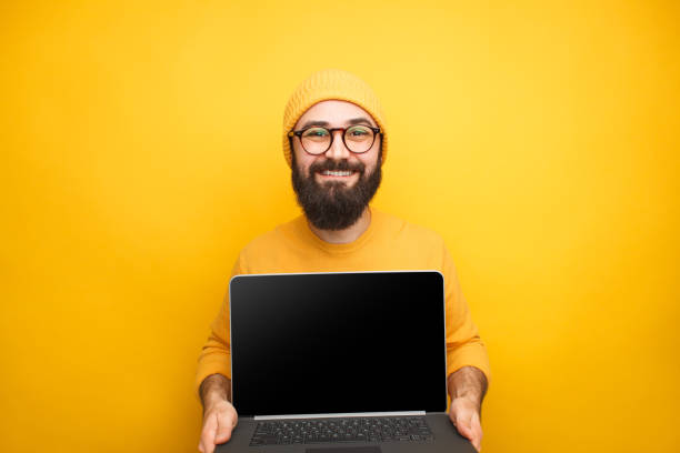 istock Handsome hipster showing laptop 1092169308