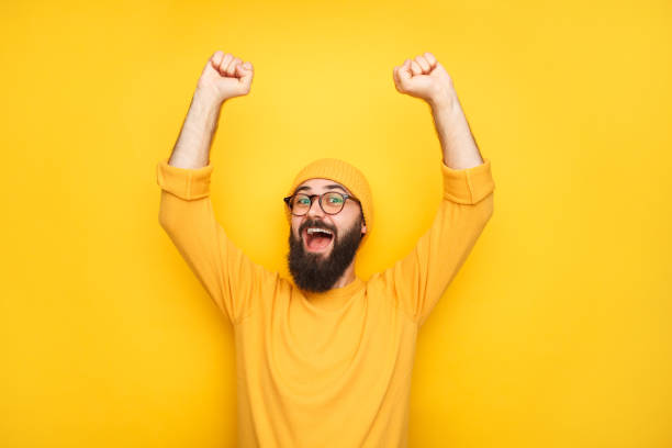 istock Happy man in yellow with hands up 1092169334