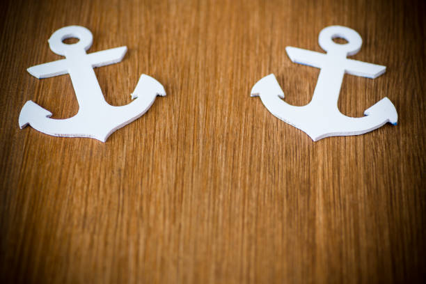 istock white decorative anchor on a wooden background 1092171744